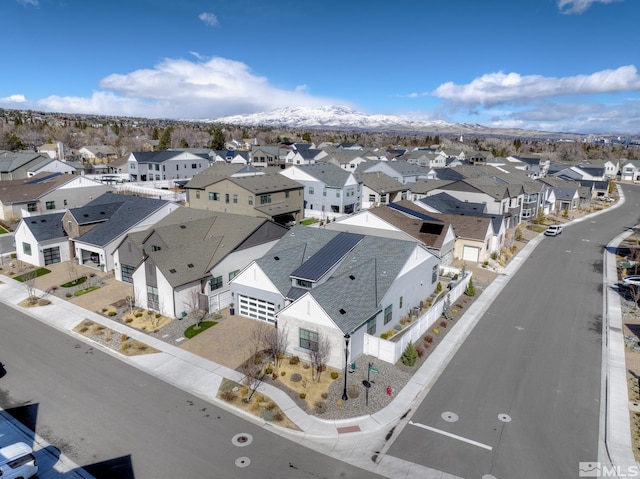 drone / aerial view featuring a residential view and a mountain view