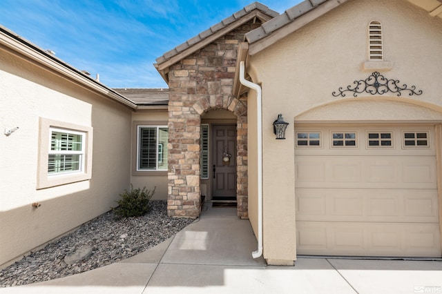 doorway to property with stone siding and stucco siding