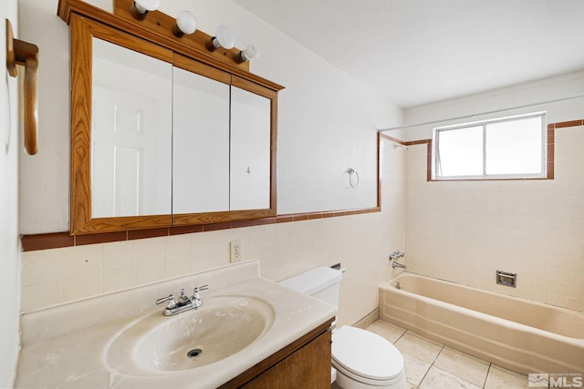 full bathroom featuring toilet, tile walls, tile patterned flooring, tub / shower combination, and vanity