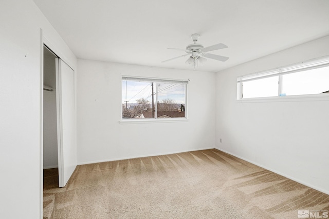 unfurnished bedroom with carpet flooring, a ceiling fan, and a closet