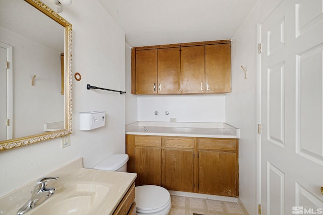 bathroom featuring vanity, tile patterned floors, and toilet