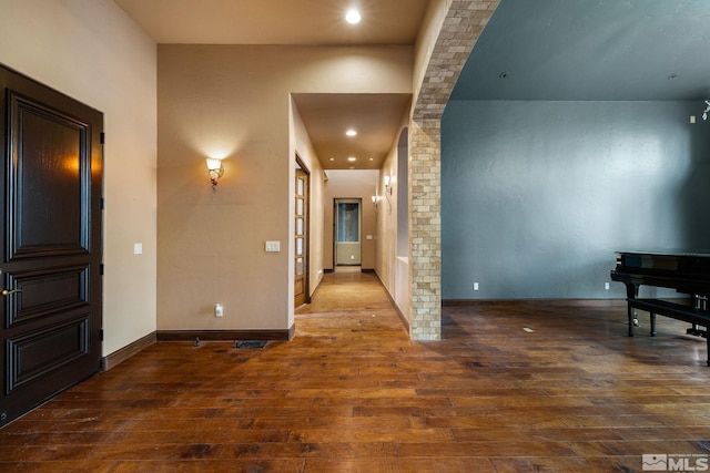 hallway with recessed lighting, baseboards, wood-type flooring, and visible vents