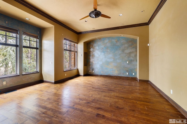 spare room with baseboards, wood-type flooring, and a ceiling fan