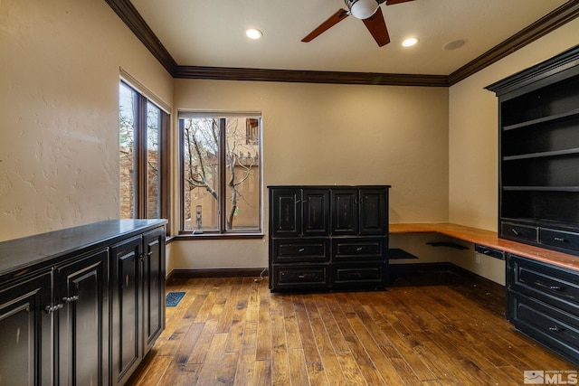 office with baseboards, crown molding, a ceiling fan, and wood finished floors