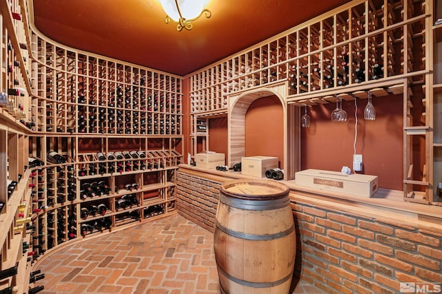 wine area featuring brick floor