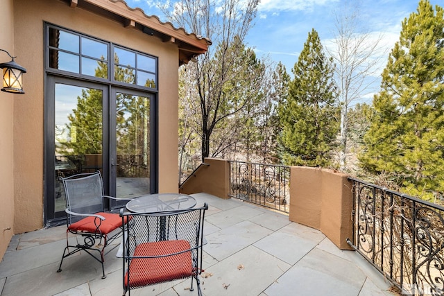 view of patio / terrace with outdoor dining space and a balcony