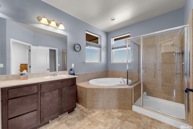 bathroom featuring tile patterned floors, a shower stall, vanity, and a garden tub