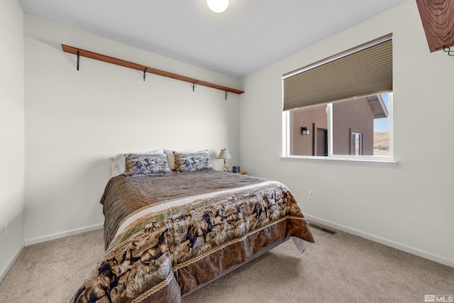 bedroom with visible vents, baseboards, and carpet