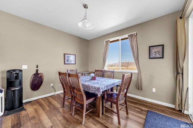 dining area featuring wood finished floors and baseboards