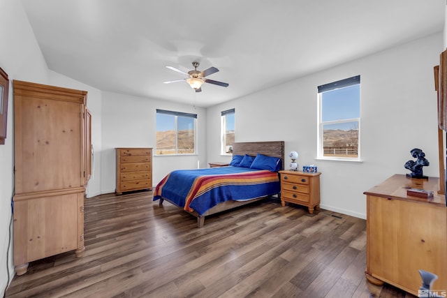 bedroom featuring a ceiling fan, dark wood-style flooring, and baseboards