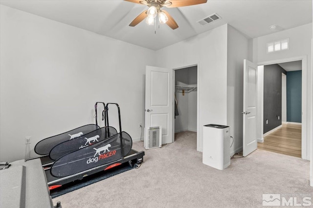 workout room featuring visible vents, carpet flooring, baseboards, and ceiling fan