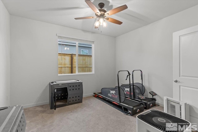 workout area featuring baseboards, carpet, and a ceiling fan