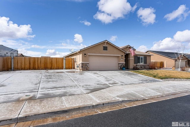 single story home with stucco siding, driveway, stone siding, fence, and an attached garage