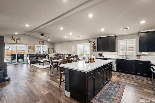 kitchen featuring a sink, visible vents, stainless steel dishwasher, and dark cabinets