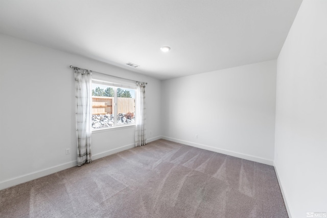 unfurnished room featuring visible vents, baseboards, and carpet flooring