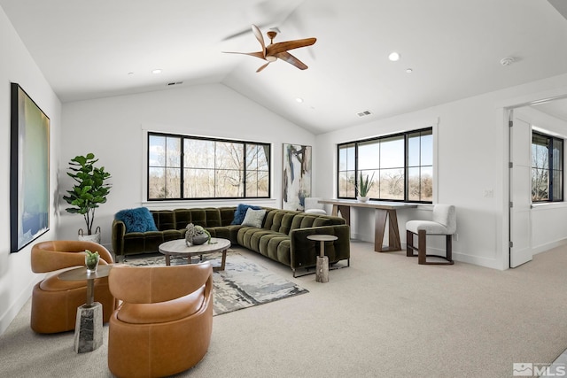 carpeted living room with lofted ceiling, baseboards, visible vents, and ceiling fan