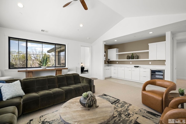 living room featuring beverage cooler, visible vents, lofted ceiling, recessed lighting, and ceiling fan