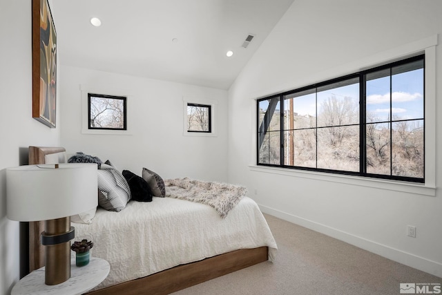 bedroom with visible vents, baseboards, carpet flooring, and vaulted ceiling