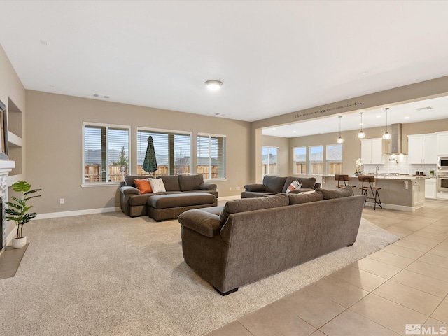 living area with recessed lighting, visible vents, baseboards, and light tile patterned flooring