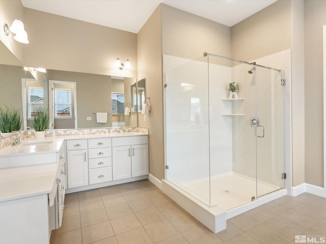 full bath featuring a shower stall, double vanity, and a sink