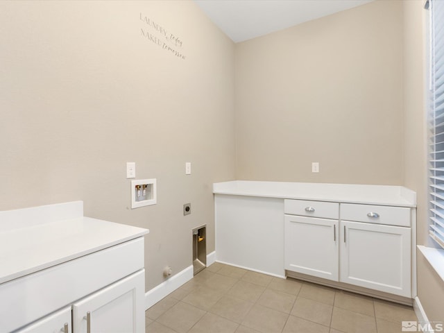 clothes washing area with electric dryer hookup, cabinet space, light tile patterned floors, gas dryer hookup, and hookup for a washing machine