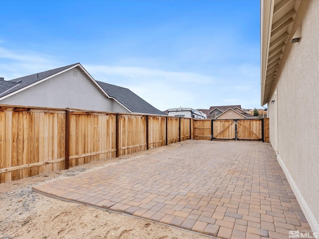 view of patio with fence and a gate