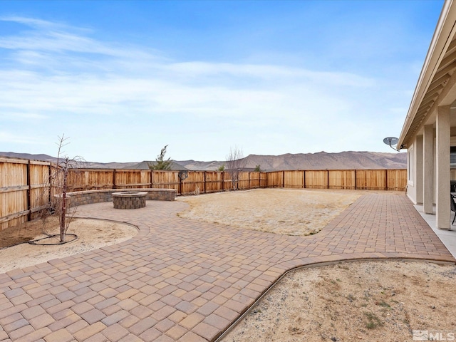 view of patio / terrace featuring an outdoor fire pit and a fenced backyard