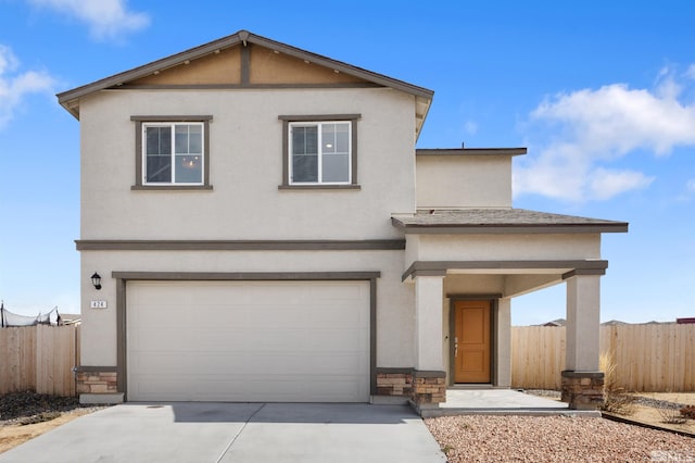 traditional-style home featuring fence, concrete driveway, stucco siding, a garage, and stone siding