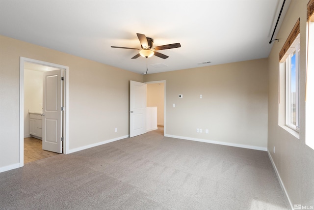 unfurnished bedroom featuring visible vents, baseboards, and carpet floors