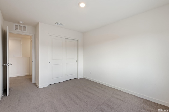 unfurnished bedroom featuring carpet flooring, baseboards, and visible vents