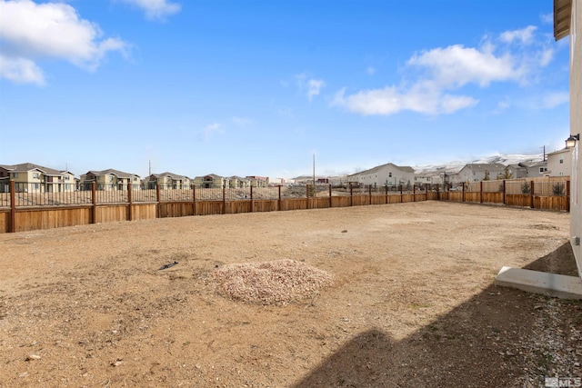 view of yard featuring a residential view and fence