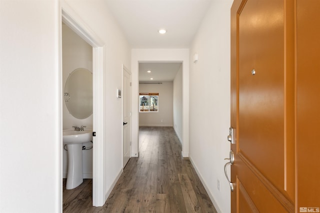 hallway with recessed lighting, baseboards, arched walkways, and wood finished floors