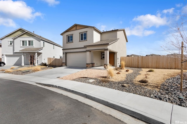 traditional-style house with concrete driveway, fence, a garage, and stucco siding