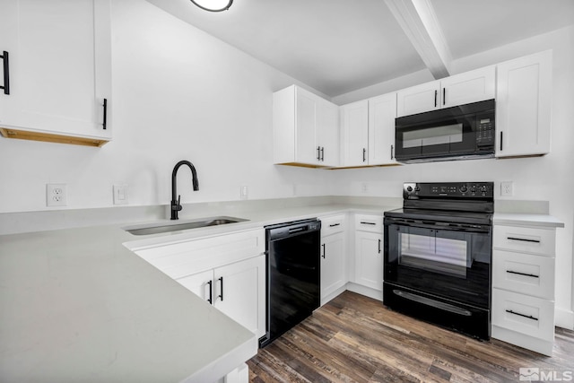 kitchen with black appliances, a sink, dark wood-style floors, white cabinetry, and light countertops