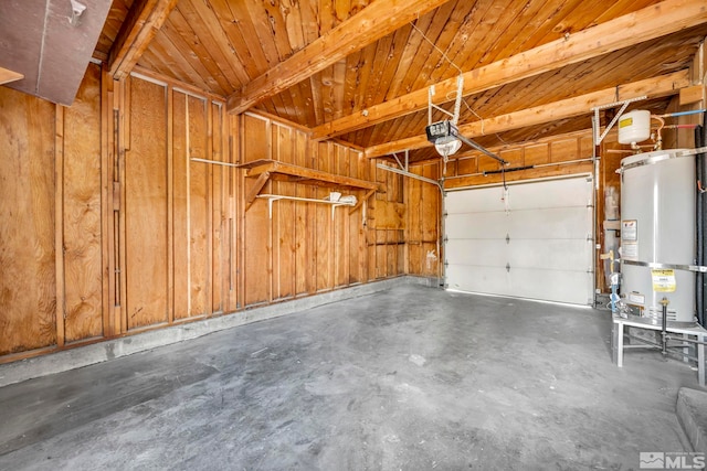 garage with strapped water heater, wooden walls, and a garage door opener