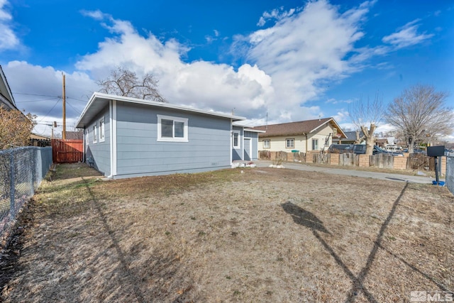 back of property featuring a yard and a fenced backyard