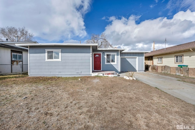 single story home with an attached garage, fence, board and batten siding, and driveway