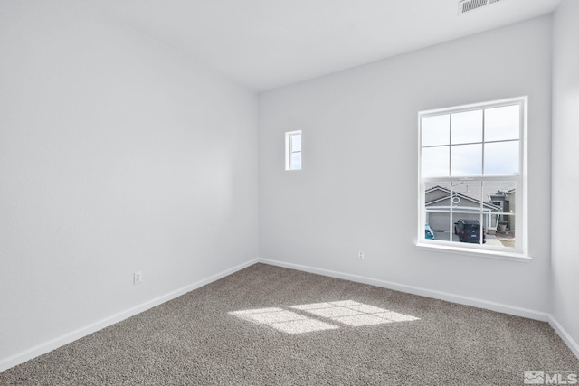 carpeted empty room with baseboards