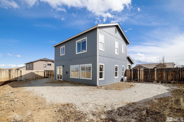 back of property with a fenced backyard