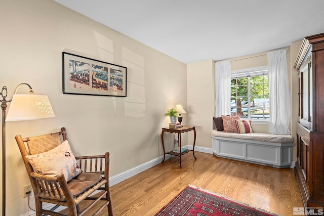 sitting room with wood finished floors and baseboards