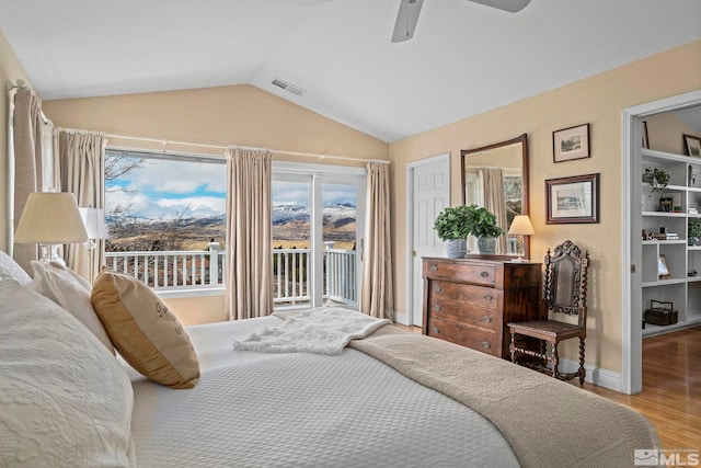 bedroom with visible vents, ceiling fan, vaulted ceiling, wood finished floors, and access to outside