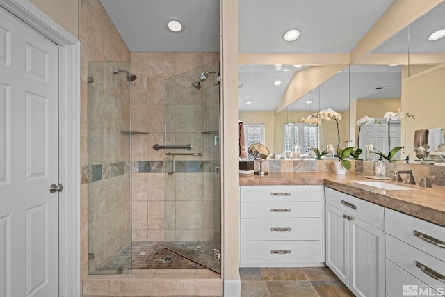 full bath with a stall shower and vanity