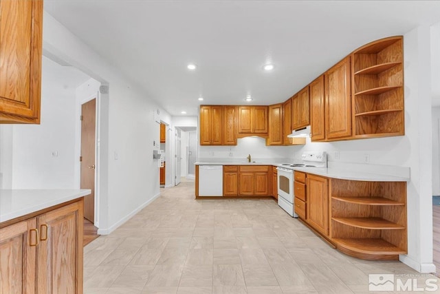 kitchen with open shelves, light countertops, white appliances, and a sink