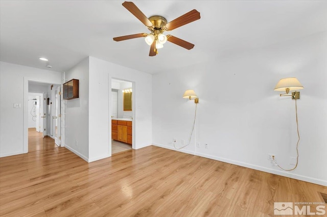 unfurnished room featuring light wood-type flooring, baseboards, and ceiling fan