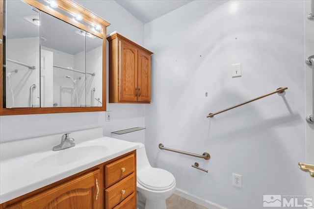 full bath featuring toilet, vanity, and walk in shower