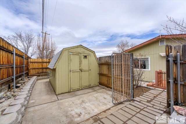 view of shed with a gate and a fenced backyard