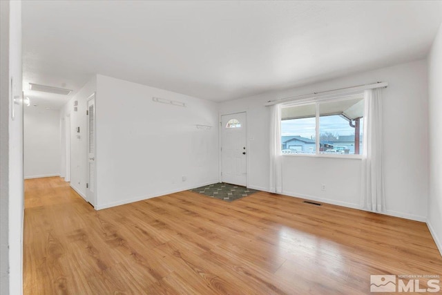 entrance foyer with light wood finished floors, visible vents, and baseboards