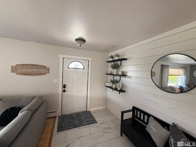 entryway with a baseboard heating unit, wooden walls, and marble finish floor