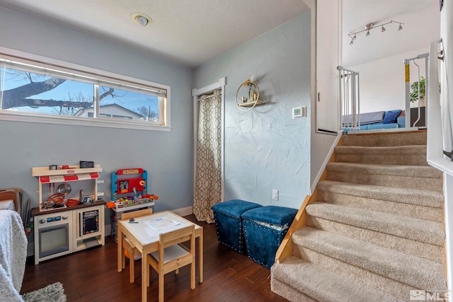 game room featuring baseboards and wood finished floors