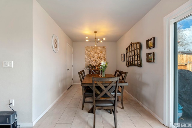 dining space with light tile patterned floors, baseboards, and an inviting chandelier